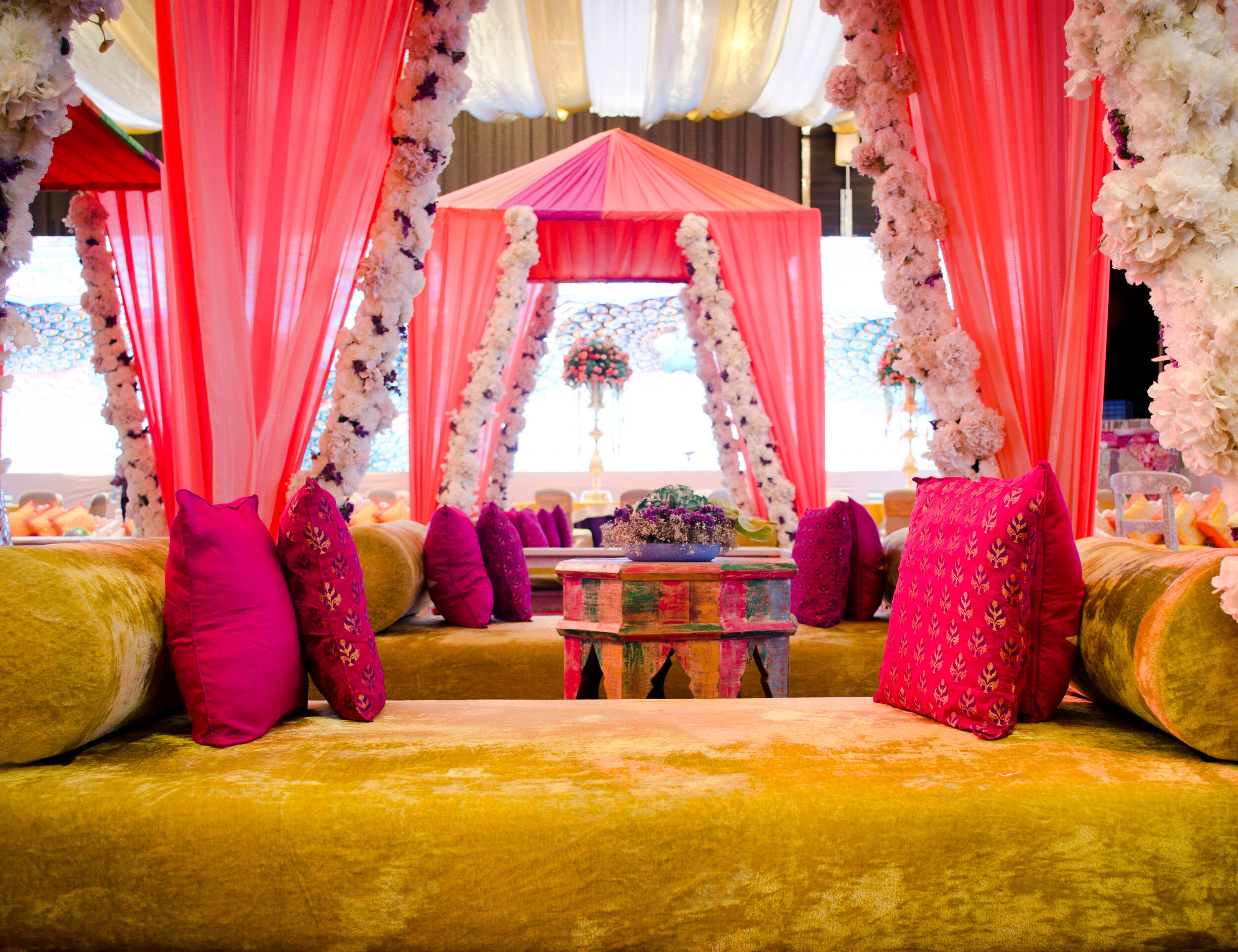 Vibrant and elegant Haldi ceremony decoration with floral arrangements and festive décor.